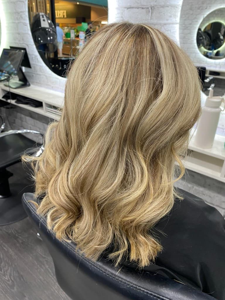 Blonde balayage and soft waves styled in the salon
